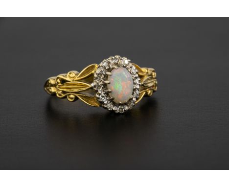 A Victorian style 18ct gold, opal and diamond cluster ring London 1976, the oval opal within a border of eight cut diamonds, 