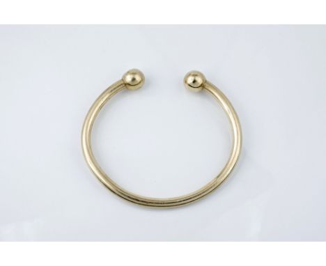 A 9ct yellow gold torq style bangle 