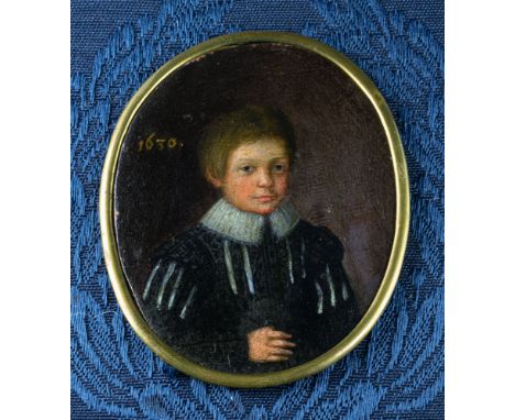 An early 17th century portrait miniature of a boy oil on copper, oval, the boy in a black doublet, the sleeves and front slas