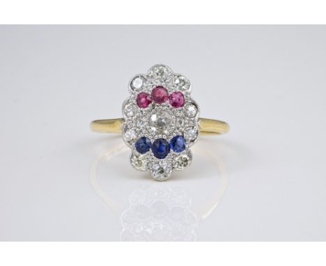 An antique 18ct gold, platinum, ruby, sapphire and diamond Empire style ring the shallow, scalloped basket millegrain set wit