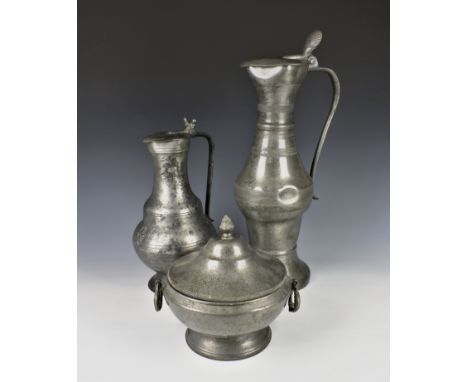 A large 18th century French pewter pitcher or flagon of waisted form with long ribbed neck, scroll handle, the hinged cover h