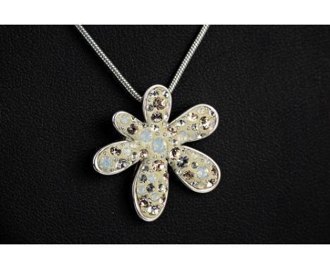 A Swarovski flower pendant together with a crystal set bangle; and a pair of pink crystal earrings, all boxed. (3)  