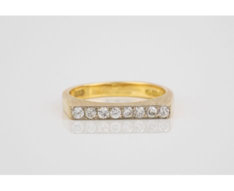 An 18ct yellow gold and diamond ring hallmarked London 1977, the flat topped, burnished shank set with eight brilliant cut di