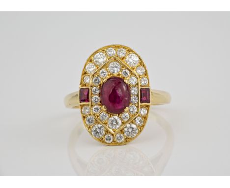 An 18ct gold, ruby and diamond Art Deco style cluster ring the central cabochon ruby within a two-tier border brilliant cut d