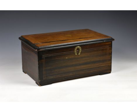 A 19th century Swiss three bell cylinder music box by Marque de Fabrique, the hinged rosewood lid with string banding and cen
