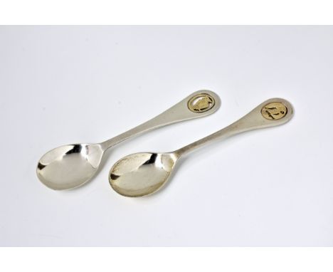 A pair of Channel Islands silver and 9ct gold novelty tea spoons by Bruce Russell date letter E (1979), the pierced terminals
