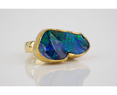 A striking handmade 18ct yellow gold and black opal ring the large, abstractly shaped opal measuring 30 x 15mm. at its widest