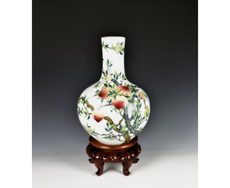 A Chinese porcelain famille rose baluster vase 20th century, with elongated neck on a hardwood stand, the body and neck decor