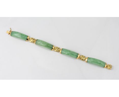 A Chinese 14ct yellow gold and jade bracelet the four curved mottled pale green jade links divided by pierced gold links deco