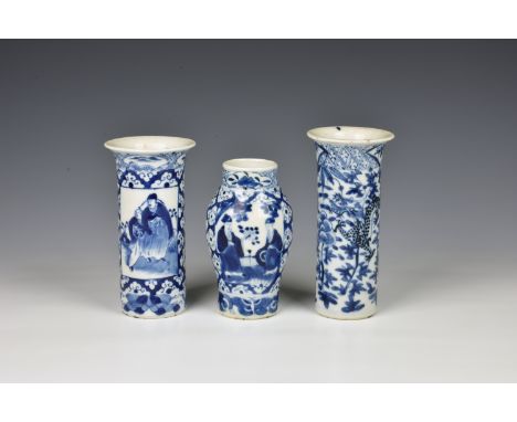 Three small Chinese porcelain blue and white vases comprising two sleeve vases, one painted with two dragons amidst flowers a