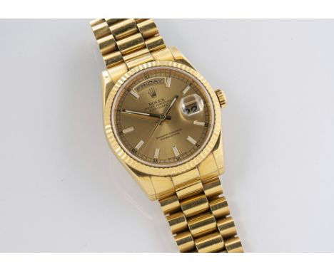 A gentleman's 18ct gold Rolex Oyster Perpetual Day-Date wrist watch c.2005/06, the 28mm. circular champagne dial with luminou