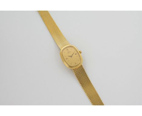 A ladies 18ct gold cased Omega wrist watch with quartz movement, the oval champagne dial signed 'Omega Swiss Made', with gilt