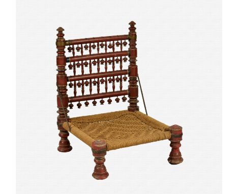 An Indian painted low chair probably early 20th century, the turned legs and uprights with bobbin and ball decoration and a w