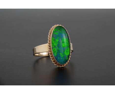 A 10ct gold and opal triplet ring the elliptical opal within a barleytwist border, size M½.  