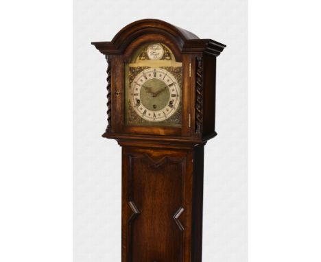 A 1930s oak grandmother clock with eight day musical movement, the brass arched dial with silvered Roman chapter ring, gilt m