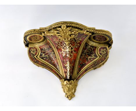 A mid-19th century Boulle clock bracket of deep serpentine form, with concave insets to the scroll edged sides, all with engr