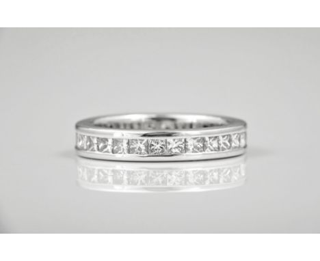 An 18ct white gold and diamond full eternity ring channel set with twenty eight princess cut diamonds, good clarity and colou