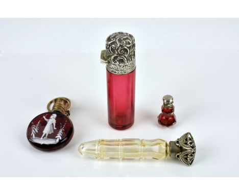 A Victorian cranberry glass and gilt metal scent bottle with Mary Gregory child overlay decoration of moon flask form, having