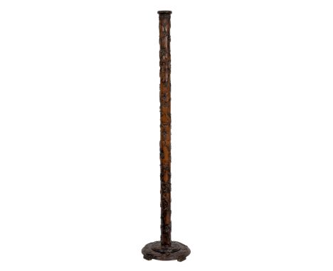 A Chinese carved hardwood standard lamp early 20th century, the sectional column with raised spiral carving of trailing prunu