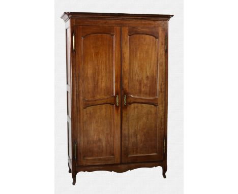 A late 18th / early 19th century French fruitwood armoire with a moulded cornice and two, two-panel doors and three-panel sid