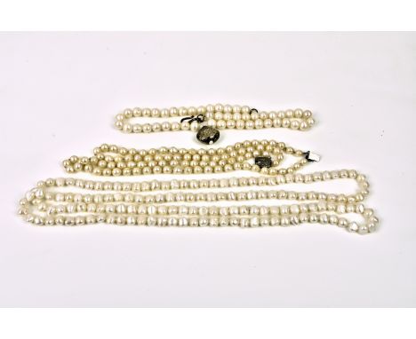 Three freshwater pearl necklaces one double strand with silver clasp; one single strand with gold plated pendant drop; the th