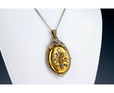 A Victorian 18ct yellow gold, pearl and diamond pendant locket the oval locket decorated with a floral spray set with pearls 