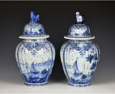 A matched pair of Delft vases and covers 19th century or earlier, of ribbed ovoid form, painted with seaside / waterways and 