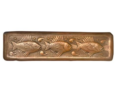 A Newlyn copper pen tray. Repousse decorated with three fish on a hammered ground, stamped mark, 7X26cm.This Newlyn piece is 