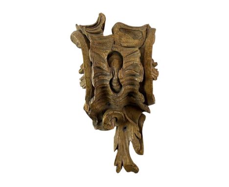 A carved pine rococo corbel or mount. 19th century, carved with leafy scrolls, height 36cm.