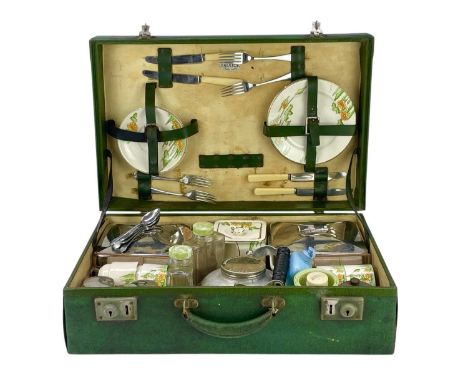 A Brexton picnic set. Contained in a green vinyl suitcase, contents include four ceramic cups and saucers, four side plates a
