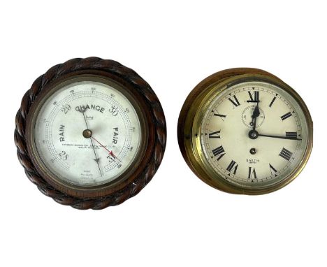 A Smith Empire brass bulkhead timepiece. Diameter of dial 14cm, together with an oak cased aneroid barometer, the dial inscri
