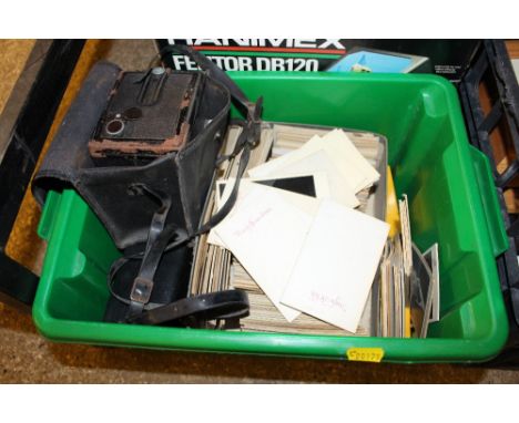A boxed projector and a box of slides; cameras etc.
