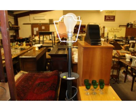 A wrought iron standard lamp