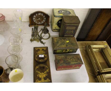 A Victorian mahogany and brass mounted extending book rack; an Art Deco walnut mantel clock; a quantity of advertising tins; 