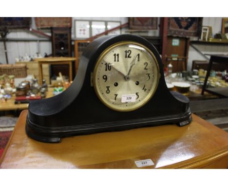 An ebonised two hole mantel clock