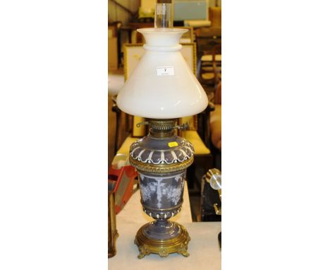 A brass and porcelain oil lamp with milk glass shade