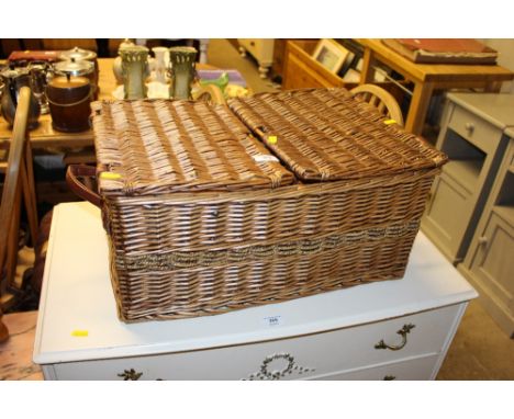 A wicker hamper containing a pair of Winnie the Pooh bookends