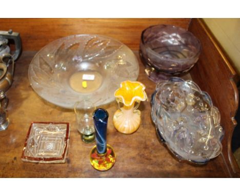 A large glass fruit bowl; an amethyst coloured glass bowl and various other glassware