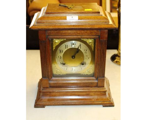 A mahogany cased two hole mantel clock with brass dial