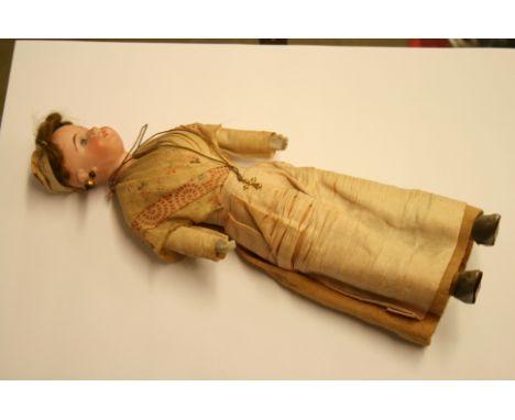A Continental bisque porcelain doll, stamped G/K numbered 44.20