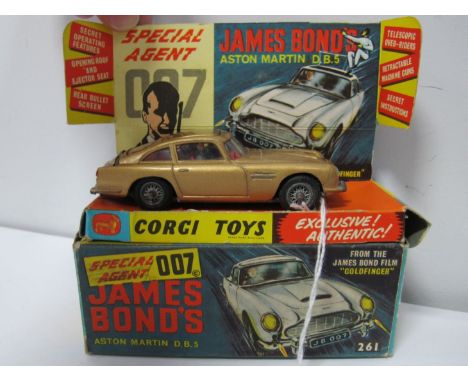 An Original Corgi #261 James Bonds Aston Martin, bright gold body, red interior, wire wheels, James Bond and baddie figures, 