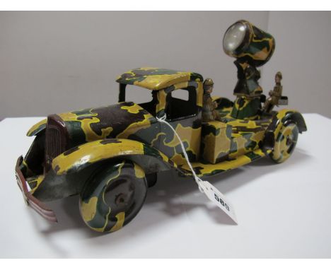 A 1940 Tinplate Clockwork Search Light Lorry by Wells Brimtoy, camouflaged finish, four wheel. Missing one figure, 36cm long,