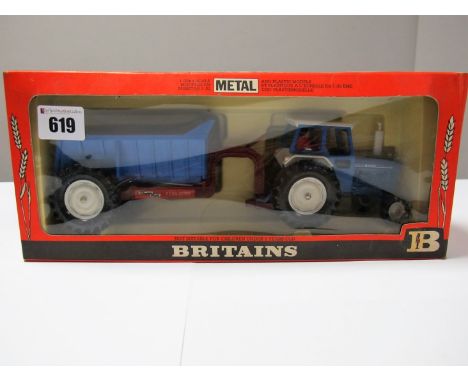 A Boxed Britains Farm #9630 1:32nd Scale Ford 6600 Tractor and Shawnee Poole Rear Dump Set, blue and maroon body and trailer,