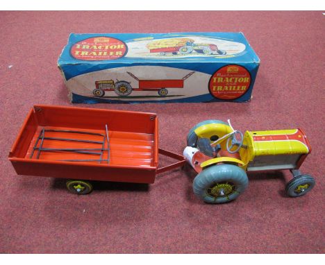 A Mid XX Century Boxed Clockwork Mettoy Mechanical Tractor and Trailer ' In Heavy Pressed Steel', fair condition, missing exh