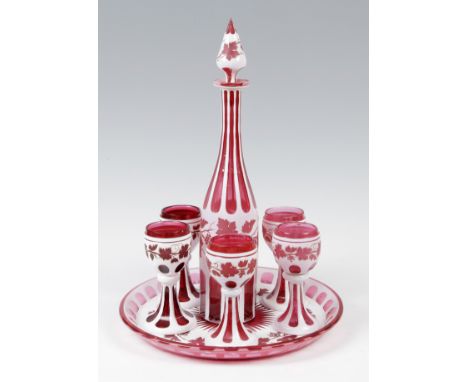 Liquor set; Bohemia, ca. 1850.Blown and carved glass.Measurements: 30.5 cm diameter of the tray; 40.5 cm height of the decant