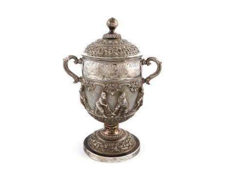 A Burmese silver hockey trophy cup and cover, circa 1903, circular form, leaf capped scroll handles, the body embossed with h