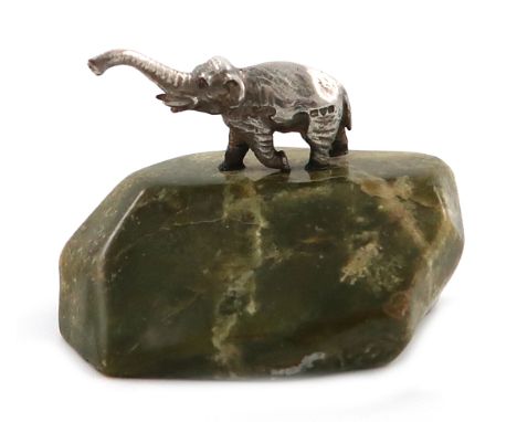 A silver model of an elephant, by S. Mordan and Co, Chester 1910, modelled in a standing position, with trunk raised, on a gr
