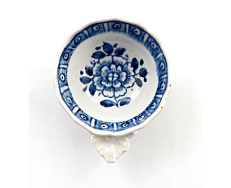 An English porcelain wine tasters,  c.1760, possibly Vauxhall, of ogee form, painted with a central flowerhead and a cell dia