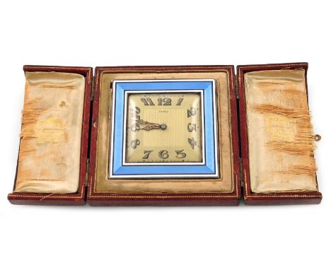 By Cartier, Paris, a metal mounted enamel travelling clock, square form, with a band of light blue enamel decoration, with wh