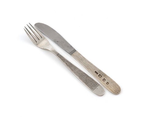 By Gerald Benney, a modern silver knife and fork, London 1969, the handles with textured decoration, the knife with a stainle